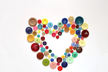 Heart of buttons isolated on a white background. Sewing with love