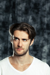 Obraz premium Portrait of handsome young thoughtful man