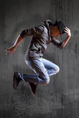 Fototapeta na wymiar Man break dancing on wall background