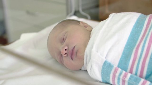 Pan Down Hospital Medical Equipment to Newborn Baby Sleeping in Delivery Room