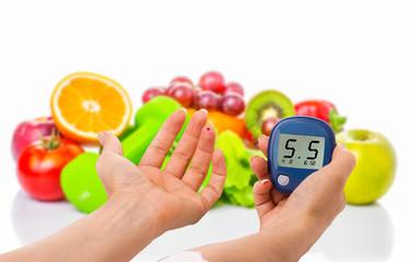glucometer for glucose level and healthy organic food on a white background. Diabetes concept