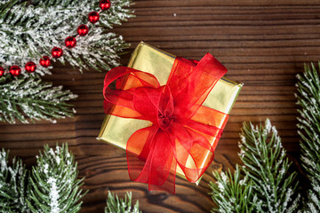 gifts boxes with fir branches on wooden background top view