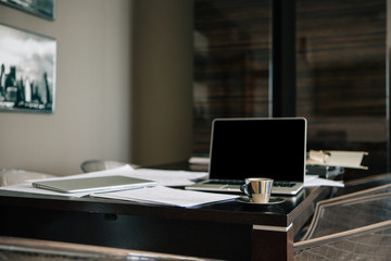 Workplace with documents and laptop