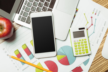 Office table with  smartphone on it. View from above