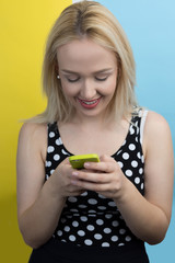 Young attractive smiling woman talking on a mobile phone on a co