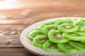 Fototapeta na wymiar Slices of kiwi on a white plate