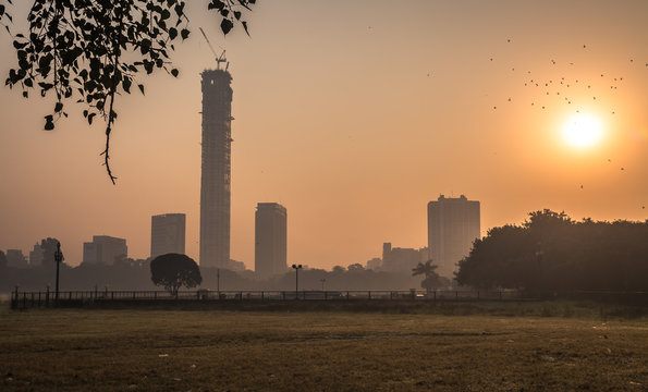 Kolkata Cityscape At Sunrise On A Misty Winter Morning. Photograph Taken From Kolkata Maidan Area.