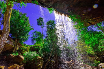 View from behind a tranquil waterfall