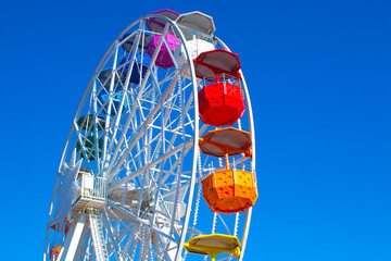 Multicolour ferris wheel on blue sky