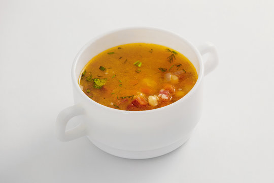 Bowl of fresh vegetable soup isolated at white background.