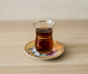 Tea in a transparent glass on the table