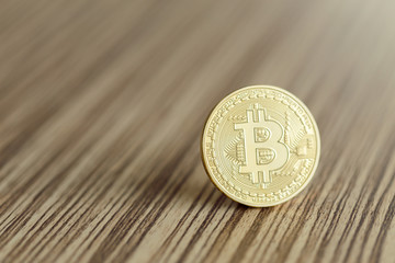 Golden Bitcoins on a wooden background