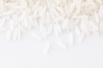 White jasmine rice close-up on white background. Decorative ending of rice.