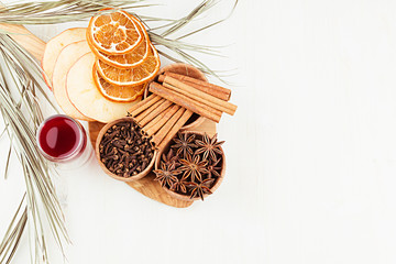 Christmas food background - mulled wine. Decorative border of  spices and drinks on white wood board. Top view. Cooking of  beverage.