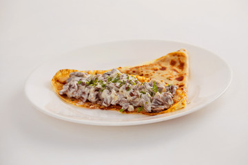 Traditional Russian meal blin stuffed with mushrooms and creme