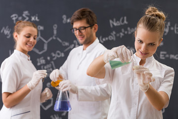 Group of three students conducting an experiment