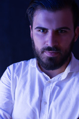 Obraz premium Portrait of a bearded man light by fluorescent light. Bearded m