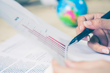 Business women hands working writing notebook on wooden desk, lighing effect
