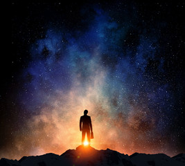 Fototapeta premium Businessman against starry sky . Mixed media