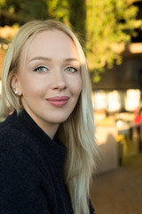 Obraz premium Beautiful young woman is looking at camera and smiling