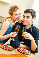 Young happy amorous couple celebrating with champagne at home. Love, relations, romantic concept shot.