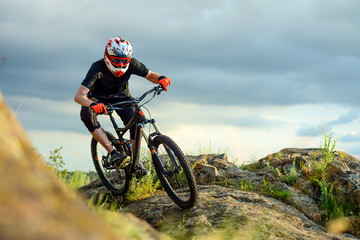 Fototapeta na wymiar Professional Cyclist Riding the Bike on the Rocky Trail. Extreme Sport.