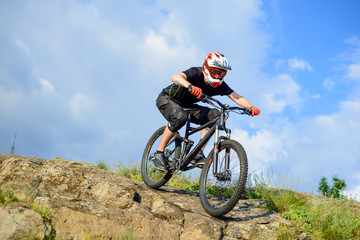 Naklejka na ściany i meble Professional Cyclist Riding the Bike Down Rocky Hill. Extreme Sport.