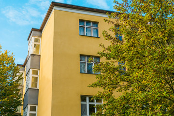 orange building with autumn trees on both sides