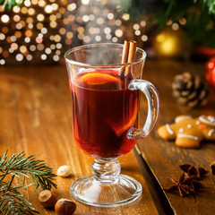 Mulled wine for Christmas Eve celebration party by Christmas tree. Hot traditional winter drink for New Year eve.