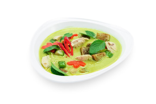 Green curry with chicken in white plate isolated