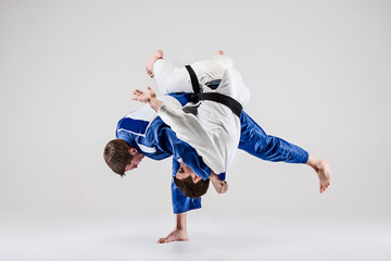 Fototapeta na wymiar The two judokas fighters fighting men