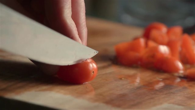 Slow motion of little tomatoes slicing. Find similar in our portfolio.