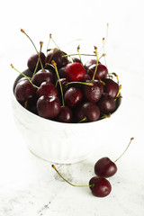 Fresh cherries in white bowl
