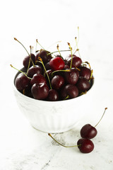 Fresh cherries in white bowl