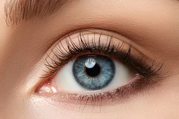 Fotobehang Close up view of beautiful blue female eye © Liudmila Dutko