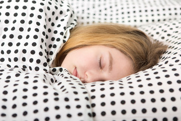 Beautiful sleeping girl resting in bed with alarm clock , The sleeping teenager 
