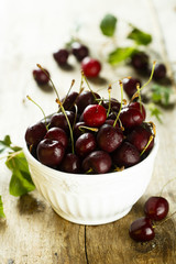 Fresh cherries in white bowl