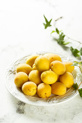 Fresh apricots on white plate