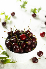 Fresh cherries in white bowl