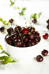 Fresh cherries in white bowl