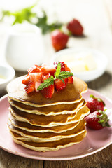 American pancakes with fresh strawberry and honey