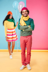 Happy woman with balloons walking on date to her boyfriend