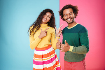 Smiling african american young couple showing thumbs up