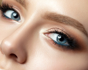 Close up view of blue woman eye with beautiful makeup