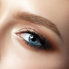 Close up view of blue woman eye with beautiful makeup
