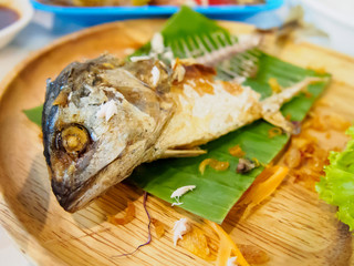 Fried mackerel fish on wooden dish