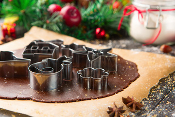 Christmas gingerbread dough, cookie cutters and spices. Xmas winter time, selective focus