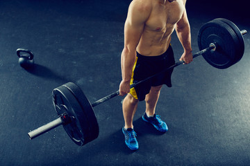 Athletic man at gym doing deadlift exercise -  overhead picture