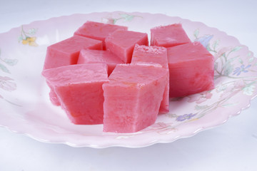 Colorful of Coconut Jelly or Layer Sweet Cake (Thai name is Kanom Chan) on white dish. Thailand ancient dessert