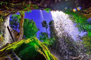View from behind a tranquil waterfall